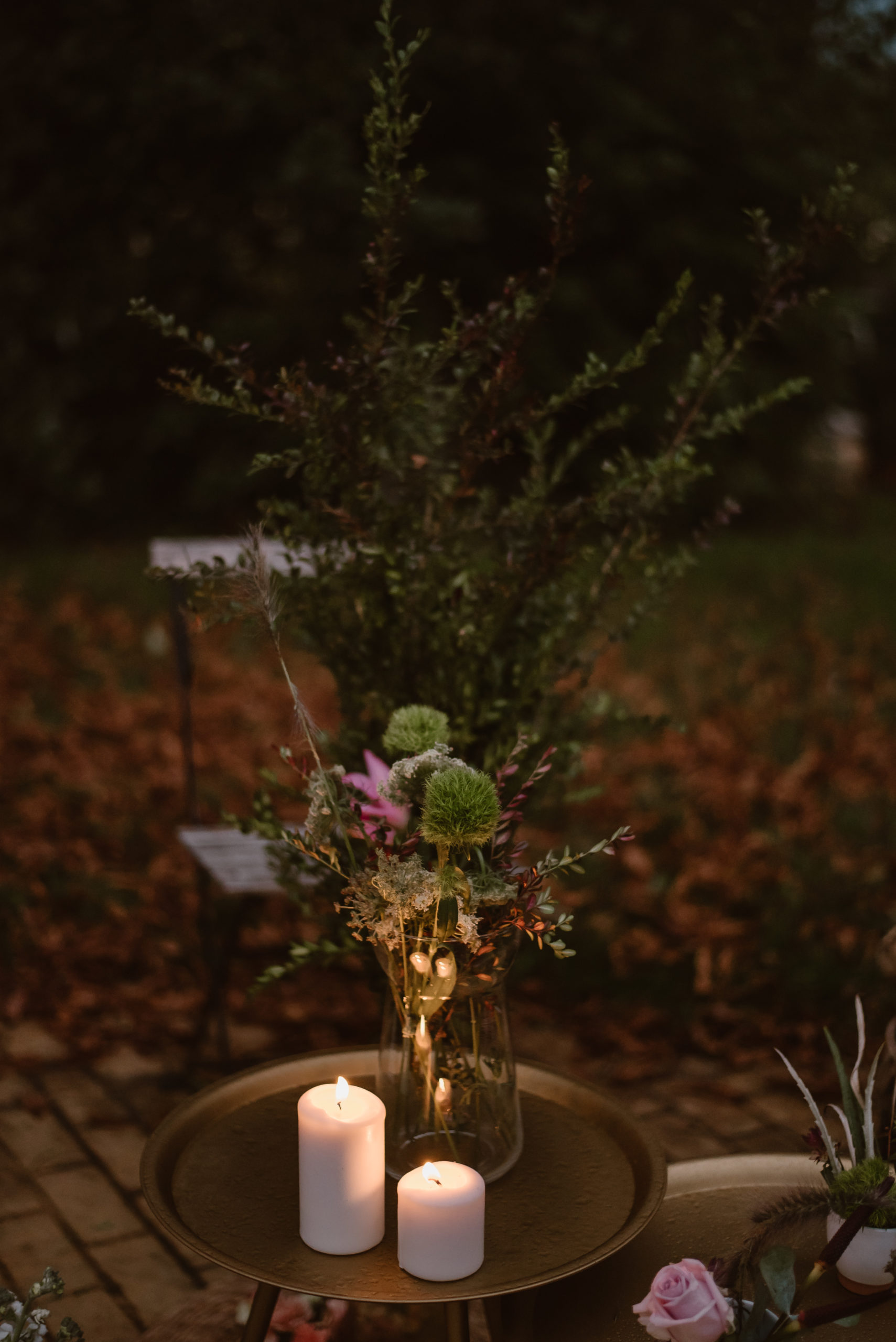 Mesa auxiliar dorada con velas y jarrones de cristal